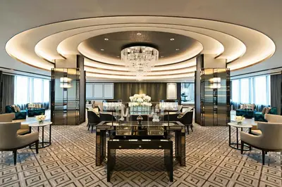 a hotel lobby with a chandelier and tables and chairs at Bangkok Marriott Marquis Queens Park in Bangkok