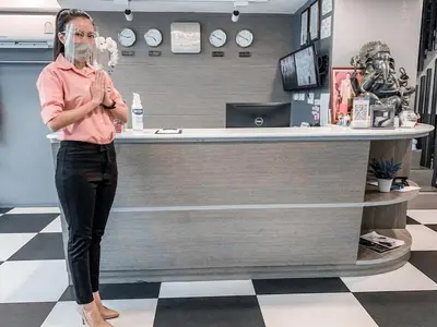 a woman standing in front of a counter in a store at Casa Residence Hotel in Bangkok