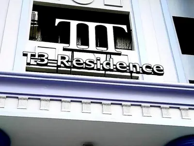 a sign on the side of a building at T3 Residence in Bangkok