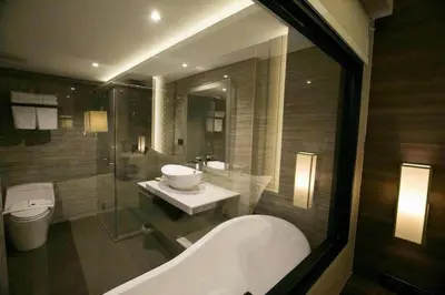 a bathroom with a tub and a sink and a toilet at Arte Hotel - SHA Extra Plus in Bangkok