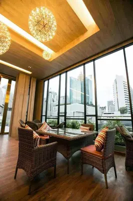 a room with a table and chairs and windows at Arte Hotel - SHA Extra Plus in Bangkok