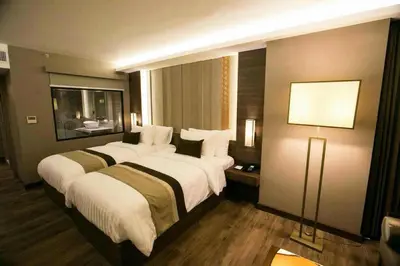 a hotel room with two beds and a lamp at Arte Hotel - SHA Extra Plus in Bangkok