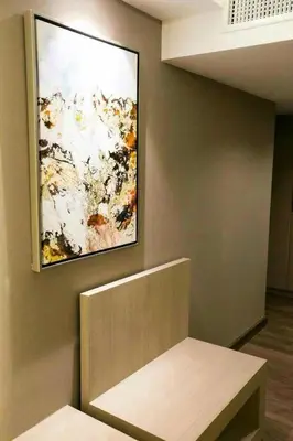 a painting hanging on a wall in a room at Arte Hotel - SHA Extra Plus in Bangkok