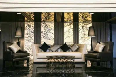 a living room with a couch and two chairs at Arte Hotel - SHA Extra Plus in Bangkok