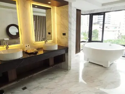 a bathroom with two sinks and a large tub at Arte Hotel - SHA Extra Plus in Bangkok