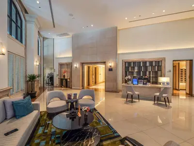 a living room with a couch and a table at Marriott Executive Apartments Bangkok, Sukhumvit 50 in Bangkok