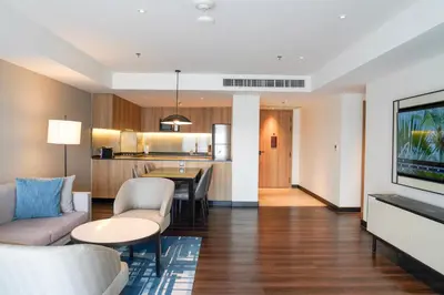 a living room with a couch and a table at Marriott Executive Apartments Bangkok, Sukhumvit 50 in Bangkok