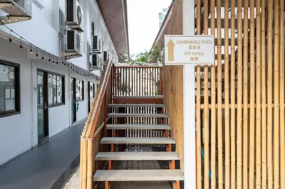 a staircase in a building with a sign on it at The President Hotel at Chokchai 4 in Bangkok