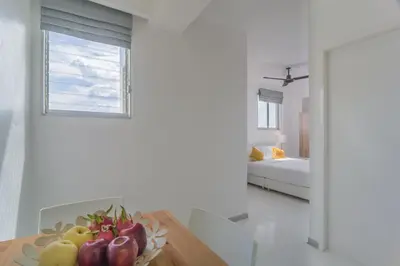 a dining room with a table with a bowl of fruit at ST88 Residence in Nonthaburi