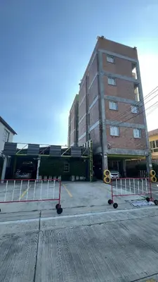 a large brick building with barriers in front of it at ST88 Residence in Nonthaburi