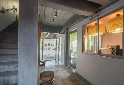 a hallway of a house with a staircase and a stool at ST88 Residence in Nonthaburi