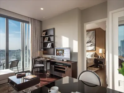 a living room with a bed and a desk with a television at 137 Pillars Residences Bangkok in Bangkok