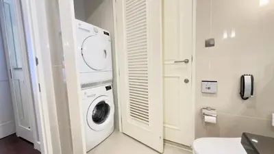a bathroom with a washer and dryer in a room at 137 Pillars Residences Bangkok in Bangkok