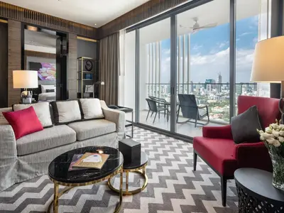 a living room with a couch and a table at 137 Pillars Suites Bangkok in Bangkok