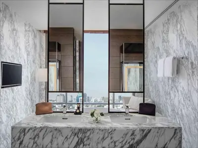 a bathroom with two sinks and a large window at 137 Pillars Suites Bangkok in Bangkok