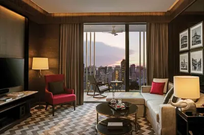 a living room with a couch and a view of a city at 137 Pillars Suites Bangkok in Bangkok