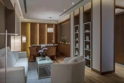 a living room with a white couch and a table at 137 Pillars Suites Bangkok in Bangkok