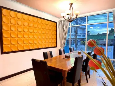 a dining room with a table and a large window at ลีลาวดี รามอินทรา - Leelawadee Resotel Raminthra 23 in Bangkok