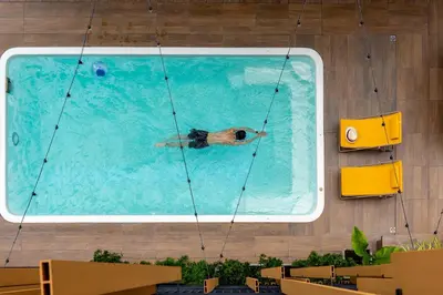 a person swimming in a swimming pool at Nest by Sangob in Bangkok