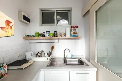 a kitchen with a sink and a counter top at 1BR Condo 5 Min to BTS 1000Mbps Fiber Wi-Fi great location in Bangkok