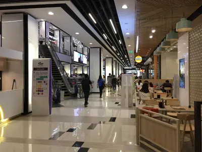 a shopping mall with people walking through the store at 1BR Condo 5 Min to BTS 1000Mbps Fiber Wi-Fi great location in Bangkok