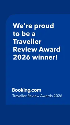 a blue sign that says were proud to be a traveller reviewagency winner at 1BR Condo 5 Min to BTS 1000Mbps Fiber Wi-Fi great location in Bangkok