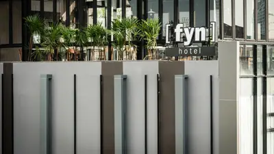 a facade of a building with a hotel sign at Fyn Hotel in Bangkok
