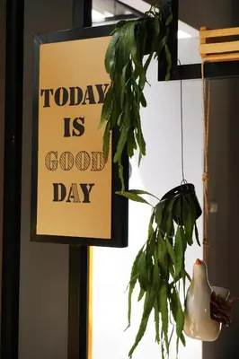 a sign that says today is good day with a plant at Hansa Bangkok House in Bangkok