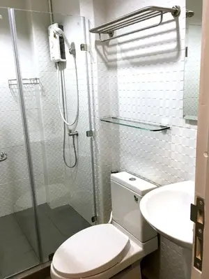 a bathroom with a shower and a toilet and a sink at Urban Hostel Bangkok in Bangkok