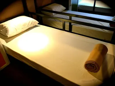 a brown roll of paper sitting on top of a bed at Urban Hostel Bangkok in Bangkok