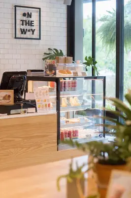 a bakery with a display case filled with food at The Journey Hotel Laksi in Bangkok