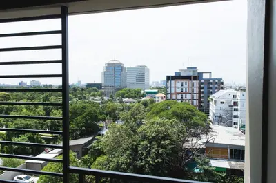 a view of a city from a window at The Journey Hotel Laksi in Bangkok