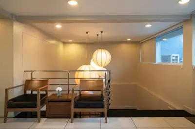 a dining room with two chairs and a table at Bangkok Loft Inn in Bangkok