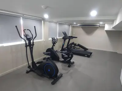 a gym with three exercise bikes in a room at Bangkok Loft Inn in Bangkok