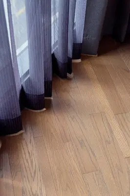 a curtain on a window with a wooden floor at Volve Hotel Bangkok in Bangkok