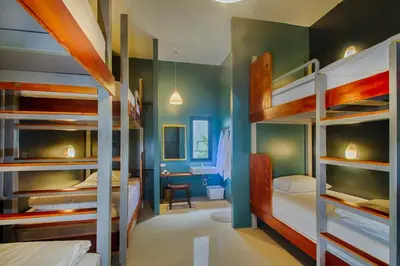 a room with several bunk beds in a room at Hom Hostel & Cooking Club in Bangkok