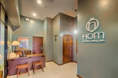 a room with a hogan healthcare clinic sign on the wall at Hom Hostel & Cooking Club in Bangkok
