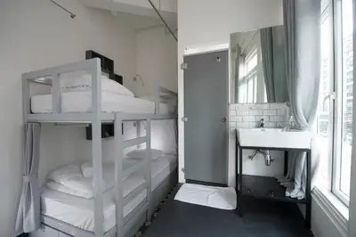 a bathroom with two bunk beds and a sink at Cacha Bed in Bangkok