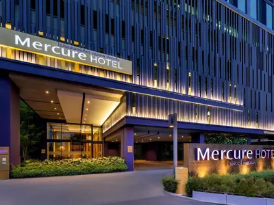 a hotel with a sign on the side of it at Mercure Bangkok Makkasan in Bangkok