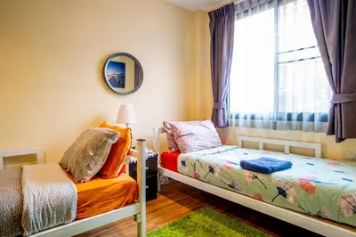a bedroom with two beds and a window at The Cube Sathorn Boutique Hotel เดอะ คิวบ์ สาทร บูติค โฮเทล Near BTS Surasak in Bangkok