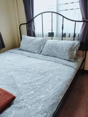 a bed with white sheets and pillows and a window at The Cube Sathorn Boutique Hotel เดอะ คิวบ์ สาทร บูติค โฮเทล Near BTS Surasak in Bangkok