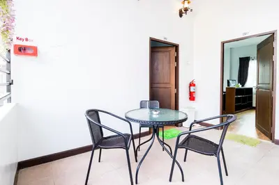 a table and two chairs in a room at The Cube Sathorn Boutique Hotel เดอะ คิวบ์ สาทร บูติค โฮเทล Near BTS Surasak in Bangkok