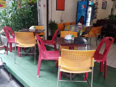 a group of tables and chairs at a restaurant at Prasuri Guest House in Bangkok