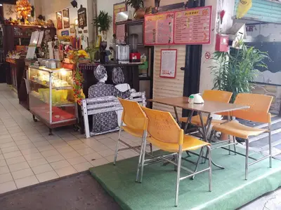 a table and chairs in front of a restaurant at Prasuri Guest House in Bangkok