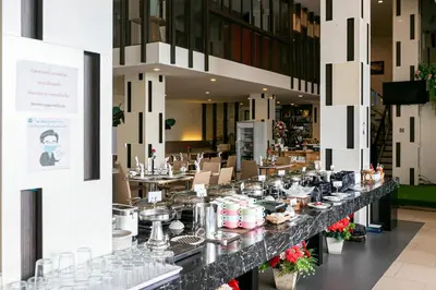 a buffet line in a restaurant with plates of food at Grand Ratchapruek Hotel in Ban Bang Phlap