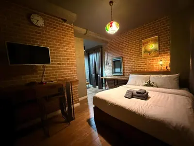 a bedroom with a bed and a brick wall at Rent V38 #420 friendly Thailand in Bangkok
