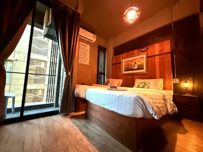 a bedroom with a bed and a large window at Rent V38 #420 friendly Thailand in Bangkok