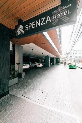 a building with a parking lot with cars parked at Spenza Hotel in Bangkok
