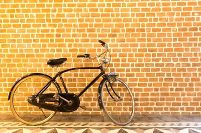 a bike parked in front of a brick wall at X9Hostel in Bangkok