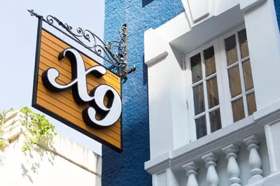 a sign on the side of a building at X9Hostel in Bangkok